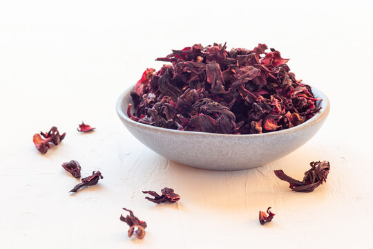 Karkade or hibiscus red tea leaves on a plate, horizontal