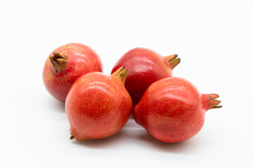 Fresh group of pomegranate closeup isolated on white background.
