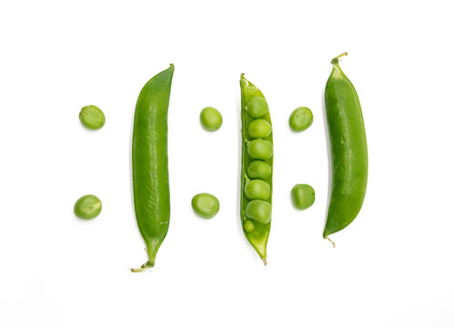 Fresh green peas on a white background, top view