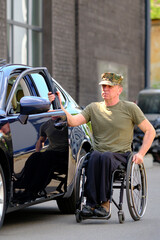 man with disability in a wheelchair near his car