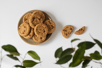 Chocolate chip cookies on a round plate, foliage frame.