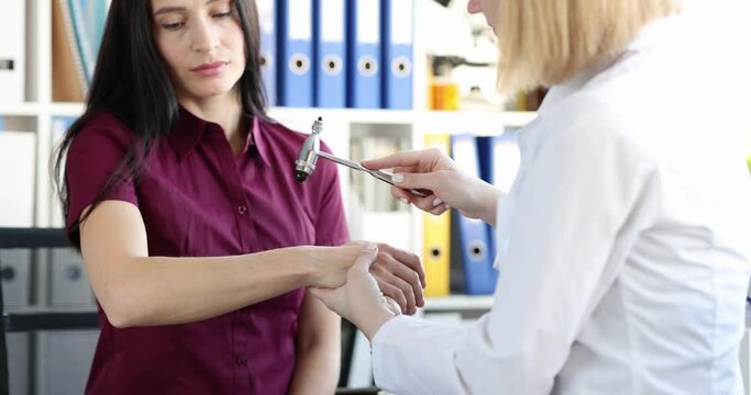 The doctor checks the hand reflex with a hammer, close-up
