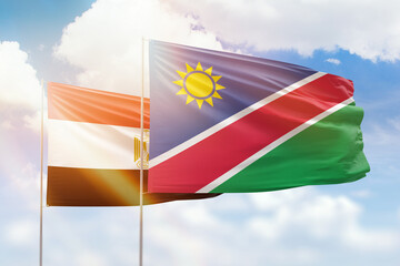 Sunny blue sky and flags of namibia and egypt