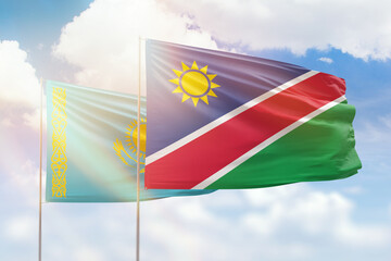Sunny blue sky and flags of namibia and kazakhstan