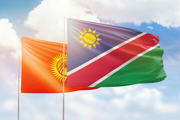 Sunny blue sky and flags of namibia and kyrgyzstan