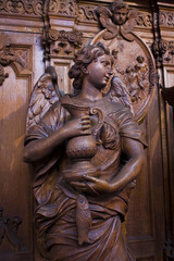 Fototapeta na wymiar Rich wooden sculptural decoration in the interior of St. Charles Borromeo Church in Antwerp, Belgium