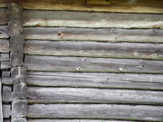 Ancient wooden walls. Old logs in the wall.