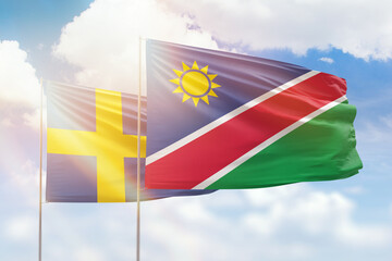 Sunny blue sky and flags of namibia and sweden