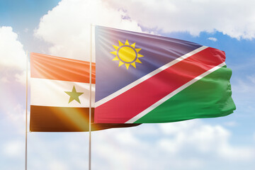 Sunny blue sky and flags of namibia and syria