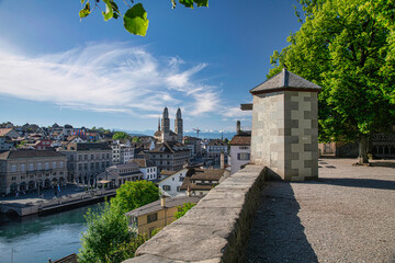 Aerial view of historic Zurich city center with famous Grossmunster Church and river Limmat from Lindenhof park, Zurich, Switzerland. Summer landscape, sunshine weather, blue sky and sunny day