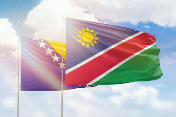Sunny blue sky and flags of namibia and bosnia