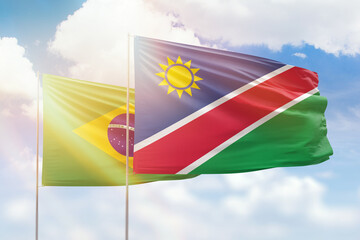 Sunny blue sky and flags of namibia and brazil