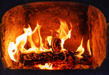 Flame of Wooden logs being burn inside stove