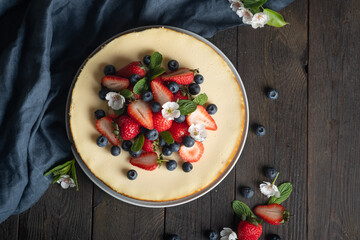 Homemade  delicious  cheesecake with fresh berries (strawberry,  blueberry) for a girl's birthday.