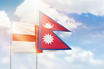 Sunny blue sky and flags of nepal and england