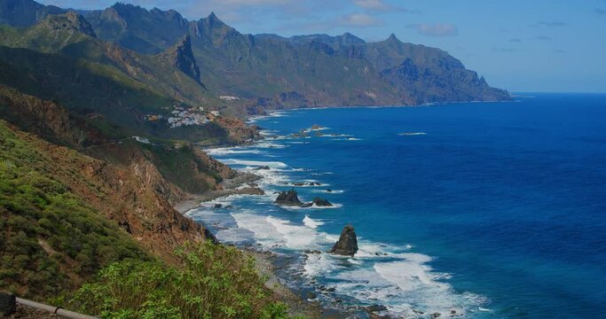 Spectacular view on rocky coast and village, Almaciga beach in Tenerife, The Canaries. Spain. Spring. Green landscape. Sunny day.