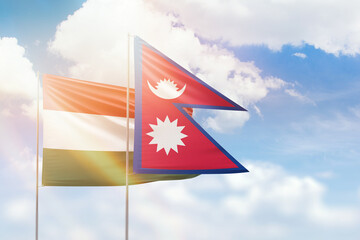 Sunny blue sky and flags of nepal and hungary