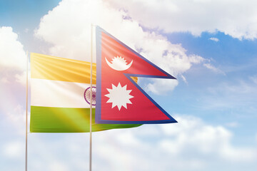 Sunny blue sky and flags of nepal and india