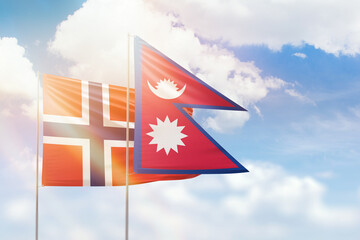 Sunny blue sky and flags of nepal and norway