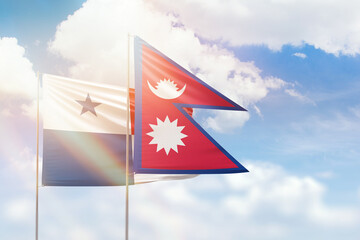 Sunny blue sky and flags of nepal and panama