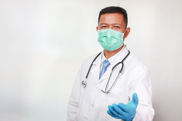 Portrait of handsome man Doctor in hospital background ,smart doctor with stethoscope wear mask at hospital or clinic,Handsome doctor in lab coat using tablet computer in clinic.