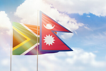 Sunny blue sky and flags of nepal and south africa