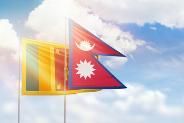 Sunny blue sky and flags of nepal and sri lanka