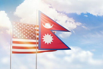 Sunny blue sky and flags of nepal and usa