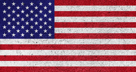 Fototapeta premium US national flag on a plastered wall
