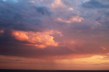 Naklejka na ściany i meble Sunset sky. Pink and blue clouds. Sky with dark clouds
