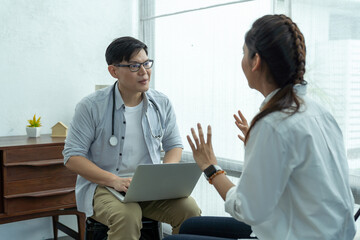 Psychologist man talking  to seek advice problems with young asian woman