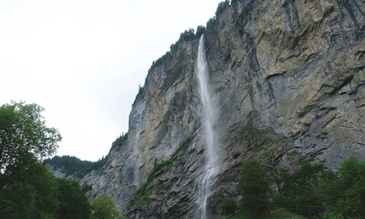 Selective focus picture of water from Staubbach Falls with rocky mountain at Lauterbrunnen. Famous tourism in Switzerland.