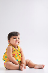 Cute indian baby girl smiling and giving expression.