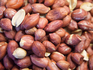 Roasted unpeeled peanuts close-up, peanuts as a background