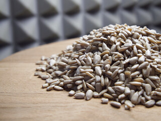 Obraz premium A pile of peeled sunflower seeds on a wooden surface, close-up