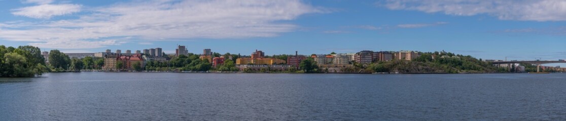 Fototapeta na wymiar Water front, color full apartment houses on the ridge Mälarhöjden a sunny summer day in Stockholm