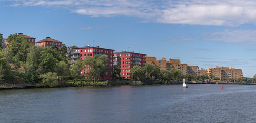Fototapeta na wymiar Water front color full apartment houses at the pier Ekensberg a sunny summer day in Stockholm