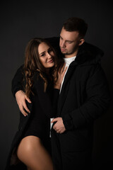 portrait of young beautiful couple on black background in studio
