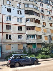 Fototapeta na wymiar 06/17/2022 Ukraine, Kharkiv, Russia's war against Ukraine. Residential high-rise building damaged by enemy shelling in the city of Kharkov. stop the war, let's pray for Ukraine.
