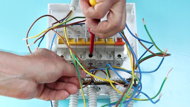 Installation of central circuit breaker panel or fuse box in house.