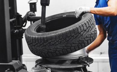 Fototapeta Professional mechanic changing tires. Concept car wheel service obraz