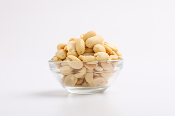 Salty peanuts in glass bowl on white background. Indian snack
