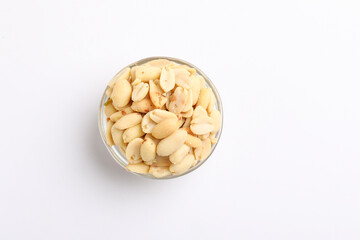 Salty peanuts in glass bowl on white background. Indian snack