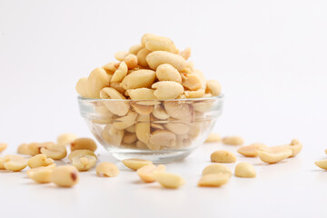 Salty peanuts in glass bowl on white background. Indian snack