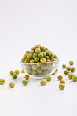 Indian snack, dry spicy green pea in glass bowl.