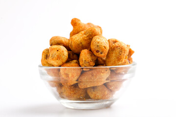 Roasted coated peanuts on white background. Delicious snack peanut.