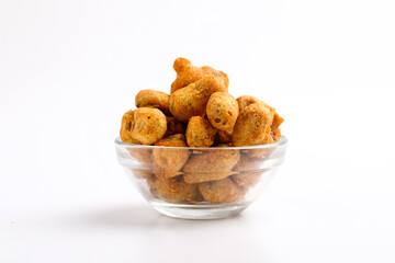 Roasted coated peanuts on white background. Delicious snack peanut.