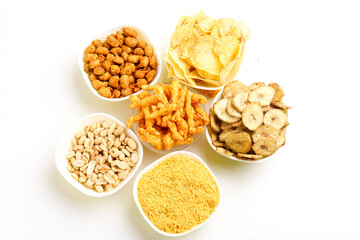 Indian snack peanuts,chips,kurkure,sev in bowl on white background.