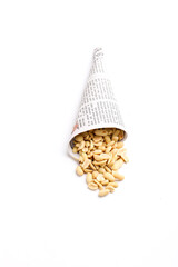 Salty peanuts in paper cone on white background. Indian snack