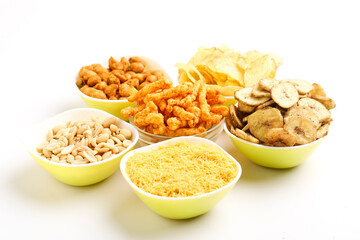 Indian snack peanuts,chips,kurkure,sev in bowl on white background.